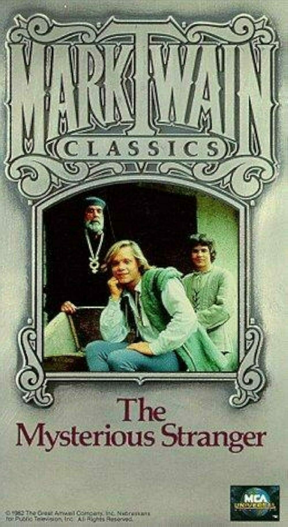 Auto-generated description: A cover of The Mysterious Stranger features three individuals in front of an ornate building with Mark Twain Classics prominently displayed.